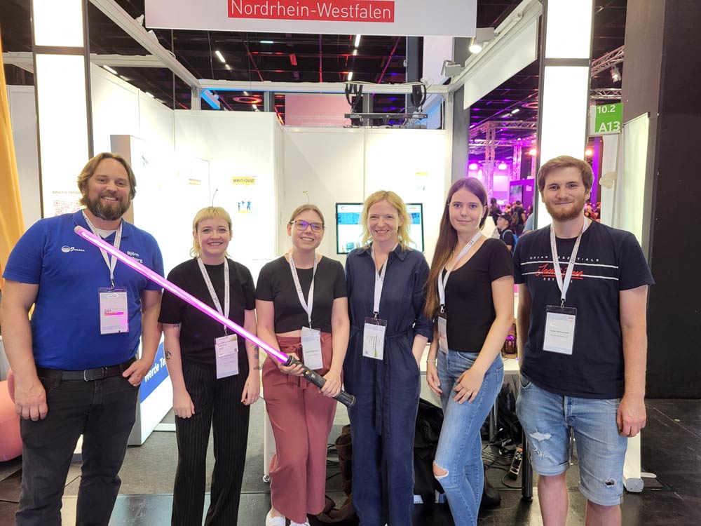 The photo shows the employees of zdi.NRW who looked after the stand at Gamescom on Saturday, August 26th. From left to right you can see: Björn Hollburg from the zdi center Mönchengladbach, Sabrina Götz, Isabell Stollenwerk and Gwendolyn Paul from the zdi-LGS, Elena from the zdi youth advisory board and Fabio Mancarella from the zdi-LGS.