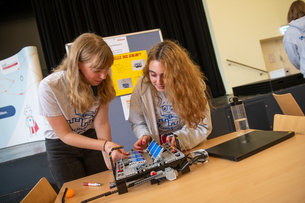 Two girls take part in the zdi robot competition.