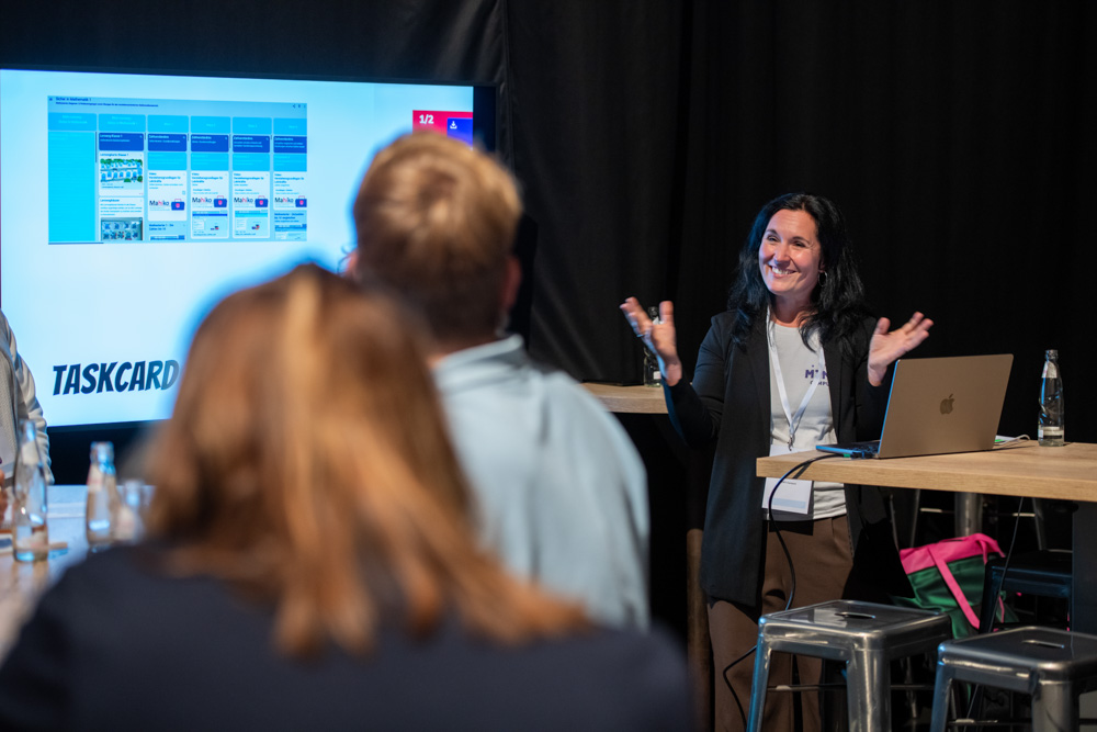 Das Foto zeigt Dozentin Melanie Below, die vor einem Bildschirm steht und digitale Tools vorstellt.