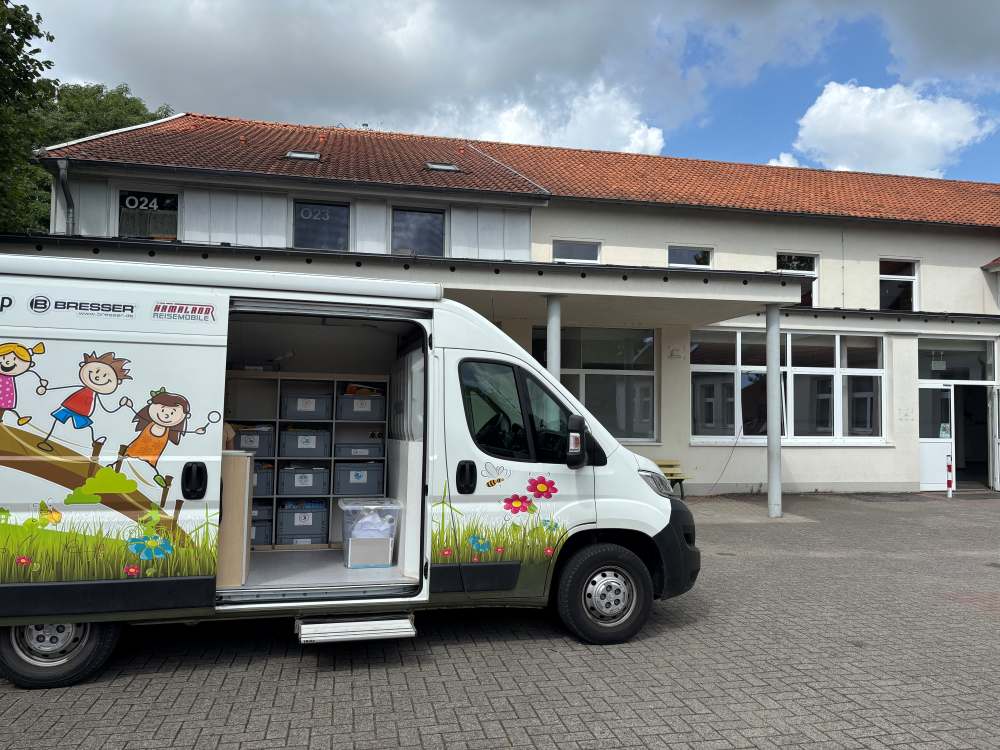 Das Foto zeigt das Forschermobil, einen weißen Van.